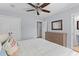 Bedroom with hardwood floors features neutral colors, dresser, and access to an ensuite bathroom at 405 Cross St, Charleston, SC 29407