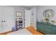 Bedroom with hardwood floors, closet, and a decorative green dresser at 405 Cross St, Charleston, SC 29407