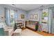 Cozy Bedroom with hardwood floors, changing table, crib, chair, and natural light at 405 Cross St, Charleston, SC 29407