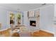 Cozy dining area featuring a brick fireplace and access to an outdoor deck at 405 Cross St, Charleston, SC 29407