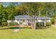 Lovely home with a well-kept lawn, established bushes, and curb appeal at 405 Cross St, Charleston, SC 29407