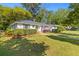 Charming home featuring a well-manicured lawn and flowering bushes at 405 Cross St, Charleston, SC 29407