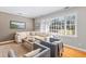 Bright living area with a plush sectional sofa, large windows, and a modern aesthetic at 405 Cross St, Charleston, SC 29407