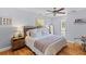 Relaxing main bedroom with a ceiling fan, hardwood floors, and a view of the ensuite bathroom at 405 Cross St, Charleston, SC 29407