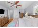 Comfortable main bedroom featuring hardwood floors, a ceiling fan, and ample natural light at 405 Cross St, Charleston, SC 29407