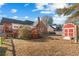 Large backyard featuring a deck, storage shed, and mature landscaping at 406 King Charles Cir, Summerville, SC 29485