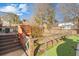 Backyard with wooden fence surrounding grass and landscaped areas, steps leading up to deck at 406 King Charles Cir, Summerville, SC 29485