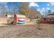 Spacious backyard features a storage shed with kayaks, a deck and a partially-fenced yard at 406 King Charles Cir, Summerville, SC 29485
