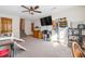Spacious finished basement features neutral carpet, ceiling fan, TV, and walkout access to upper level at 406 King Charles Cir, Summerville, SC 29485