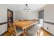 Bright dining room featuring a large wooden table, comfortable seating, and a stylish chandelier at 406 King Charles Cir, Summerville, SC 29485