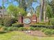 Brick Newington Plantation entrance sign surrounded by lush greenery and mulch at 406 King Charles Cir, Summerville, SC 29485