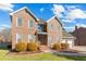 Beautiful two-story brick home featuring a manicured lawn, mature bushes, and an attached two-car garage at 406 King Charles Cir, Summerville, SC 29485