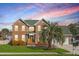Charming two-story brick home with a lush green lawn and mature landscaping under a beautiful sky at 406 King Charles Cir, Summerville, SC 29485