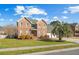 Charming two-story brick home with a green roof, a well-manicured lawn and landscaping at 406 King Charles Cir, Summerville, SC 29485