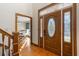 Ornate wood front door with decorative glass, hardwood floors, and a glimpse into the dining area at 406 King Charles Cir, Summerville, SC 29485