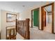 Upstairs hallway with hardwood trim, neutral carpet, and views of the front entry and a bedroom at 406 King Charles Cir, Summerville, SC 29485