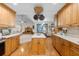 Open kitchen featuring custom wood cabinets, granite counters, hardwood floors, and seamless access to living area at 406 King Charles Cir, Summerville, SC 29485
