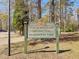 Newington Plantation Park sign is made of wood, and surrounded by greenery at 406 King Charles Cir, Summerville, SC 29485