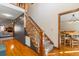 Staircase featuring hardwood floors, neutral walls, and a partial view of the living and dining areas at 406 King Charles Cir, Summerville, SC 29485