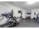 Bright workout room features rubber floor, exercise equipment and wall-mounted TV at 406 King Charles Cir, Summerville, SC 29485