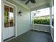 Covered back porch with green painted floor and walls with a view of the greenery in the backyard at 41 Jane Jacobs St, Mount Pleasant, SC 29464