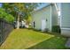 Well-maintained backyard with lush grass, a privacy fence, and an exterior of the home at 41 Jane Jacobs St, Mount Pleasant, SC 29464