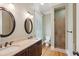 Bathroom features double sinks, dark wood cabinets, with a tiled shower with glass doors at 41 Jane Jacobs St, Mount Pleasant, SC 29464
