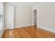 Cozy bedroom with hardwood floors, white trim, and a door leading to another room at 41 Jane Jacobs St, Mount Pleasant, SC 29464