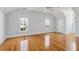 Bright bedroom featuring hardwood floors, white trim, blue walls, and natural light from multiple windows at 41 Jane Jacobs St, Mount Pleasant, SC 29464