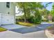 Side view of a home's garage with a driveway and lush landscaping surrounding the property at 41 Jane Jacobs St, Mount Pleasant, SC 29464