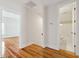 Hallway with hardwood floors, white trim, and view into bathroom and other room at 41 Jane Jacobs St, Mount Pleasant, SC 29464