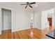 Bright living room with hardwood floors, ceiling fan, and views of powder room and staircase at 41 Jane Jacobs St, Mount Pleasant, SC 29464