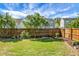 Spacious fenced backyard with green grass and trees, providing a peaceful outdoor area at 411 Freeland Way, Moncks Corner, SC 29461