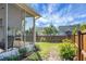 Fenced backyard features well-maintained lawn, landscaping, and screened porch at 411 Freeland Way, Moncks Corner, SC 29461