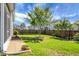 Landscaped backyard with lush green lawn, walkway, and mature trees offers privacy at 411 Freeland Way, Moncks Corner, SC 29461