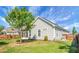 Grassy fenced backyard featuring a screened porch and mature landscaping at 411 Freeland Way, Moncks Corner, SC 29461