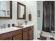 Bright bathroom features a double sink vanity, wood cabinetry, and modern faucets at 411 Freeland Way, Moncks Corner, SC 29461