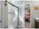 Bright bathroom features a glass shower with white tile and an adjoining bedroom at 411 Freeland Way, Moncks Corner, SC 29461