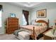 Comfortable bedroom with tray ceiling, TV, two windows with brown curtains, and floral bedspread at 411 Freeland Way, Moncks Corner, SC 29461