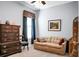 Comfortable bedroom featuring a seating area, a large dresser, a window, and blue-painted walls at 411 Freeland Way, Moncks Corner, SC 29461