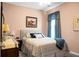 Charming bedroom featuring a comfortable bed, a dresser, and a window with blue drapes at 411 Freeland Way, Moncks Corner, SC 29461