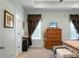 Bright bedroom features a tray ceiling, a large window with wood trim, and coordinating bedroom furniture at 411 Freeland Way, Moncks Corner, SC 29461