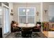 Bright dining area with a wooden table, chairs, and natural light coming in through the large window at 411 Freeland Way, Moncks Corner, SC 29461
