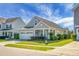 Well-maintained home with landscaped yard, two car garage, and inviting curb appeal at 411 Freeland Way, Moncks Corner, SC 29461