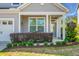 Charming front porch with seating area and manicured landscaping at 411 Freeland Way, Moncks Corner, SC 29461