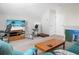 Spacious living area with a TV, desk, exercise bike, and doors leading to storage at 411 Freeland Way, Moncks Corner, SC 29461