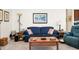 Comfortable living room setup with a blue sofa, patterned pillows, and a wooden coffee table, creating a cozy atmosphere at 411 Freeland Way, Moncks Corner, SC 29461