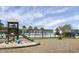 Community playground featuring swings, slides, and a sandbox adjacent to the pool and lake at 411 Freeland Way, Moncks Corner, SC 29461