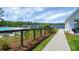 Community poolside retreat featuring lake views, comfortable seating, and lush landscaping at 411 Freeland Way, Moncks Corner, SC 29461