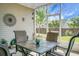 Enjoy this screened porch with furniture and view of the backyard and adjacent homes at 411 Freeland Way, Moncks Corner, SC 29461